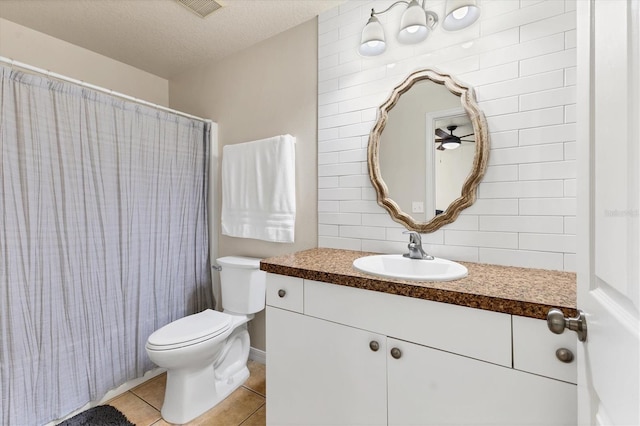 bathroom featuring walk in shower, tile patterned floors, toilet, a textured ceiling, and vanity