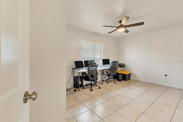 home office featuring light tile patterned floors, a textured ceiling, and ceiling fan