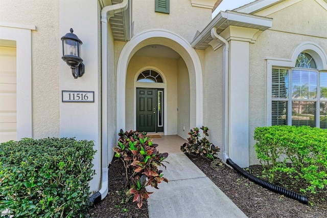 property entrance with stucco siding