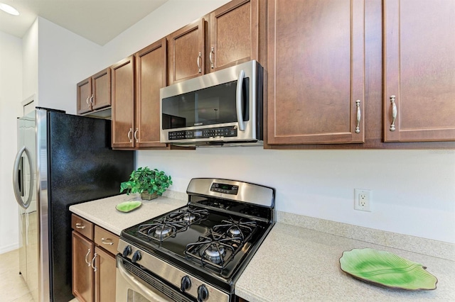 kitchen featuring stainless steel appliances and light countertops