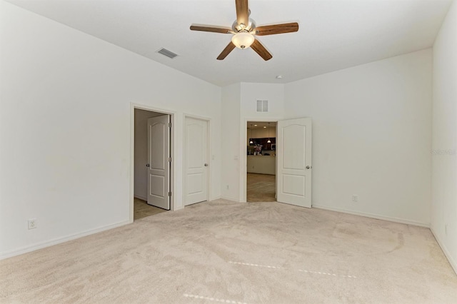 unfurnished room featuring visible vents, baseboards, carpet, and ceiling fan