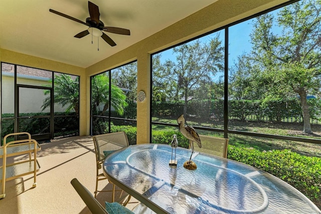 sunroom with a ceiling fan and a wealth of natural light