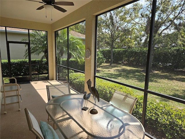 sunroom featuring ceiling fan