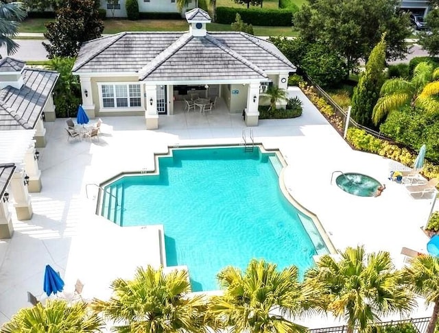 community pool featuring a patio and fence