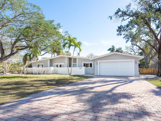 ranch-style home featuring a garage