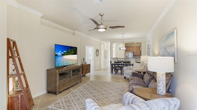 tiled living room featuring crown molding and ceiling fan