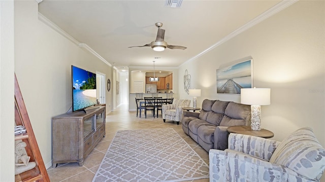 tiled living room featuring ornamental molding and ceiling fan