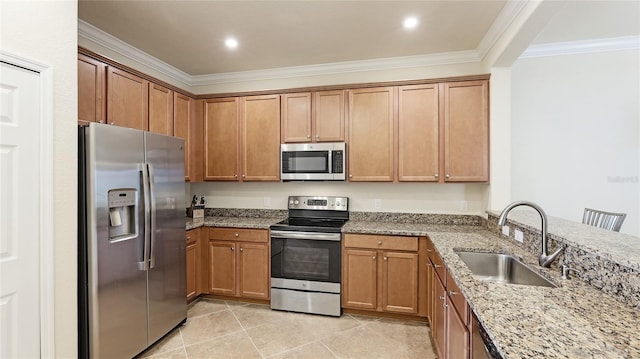 kitchen with light tile patterned flooring, sink, ornamental molding, stainless steel appliances, and light stone countertops