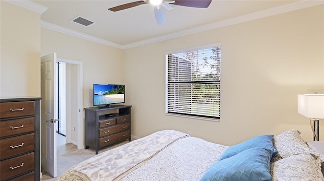 carpeted bedroom featuring crown molding and ceiling fan