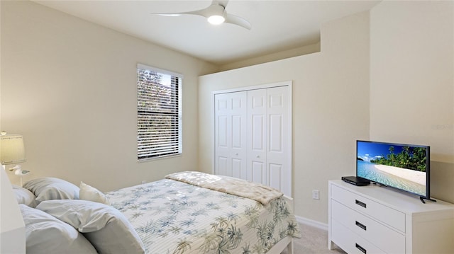 carpeted bedroom featuring a closet and ceiling fan