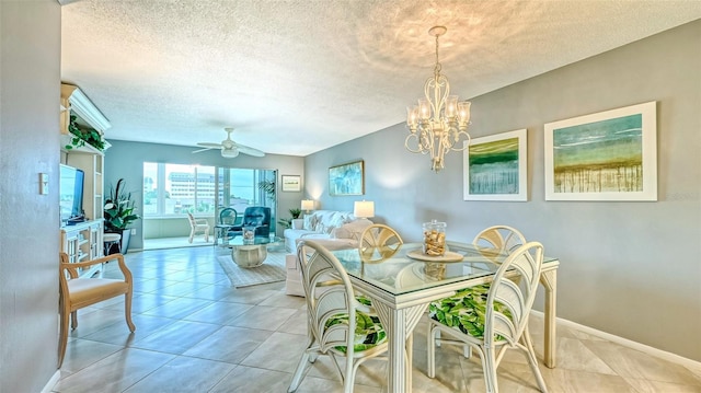 dining room featuring ceiling fan with notable chandelier, a textured ceiling, and light tile patterned floors