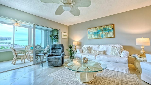 tiled living room featuring a textured ceiling and ceiling fan