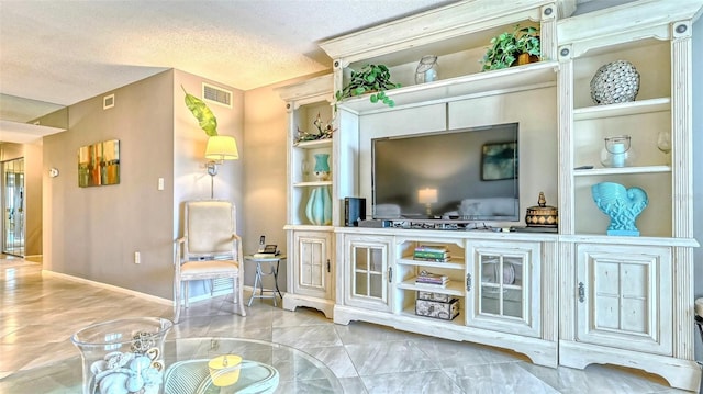 sitting room featuring built in features and a textured ceiling