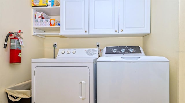 laundry room with cabinets and washer and dryer