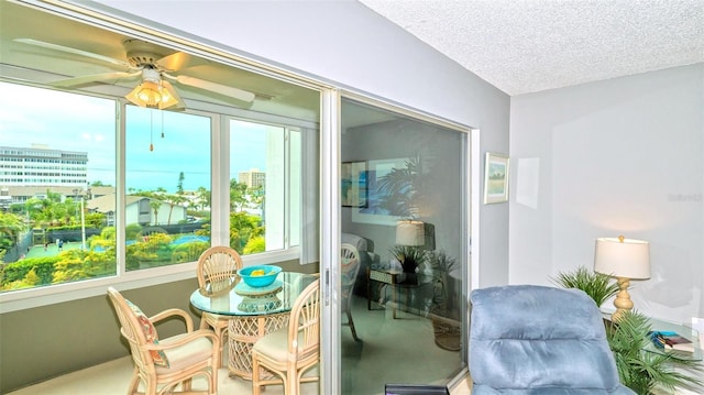 sunroom / solarium featuring ceiling fan