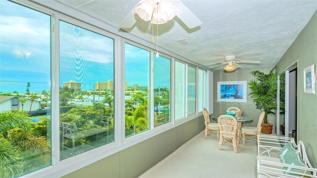 sunroom featuring ceiling fan