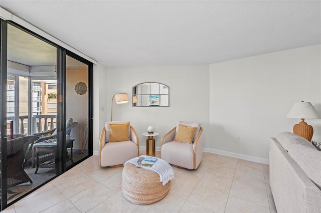 living area featuring a textured ceiling and light tile patterned floors