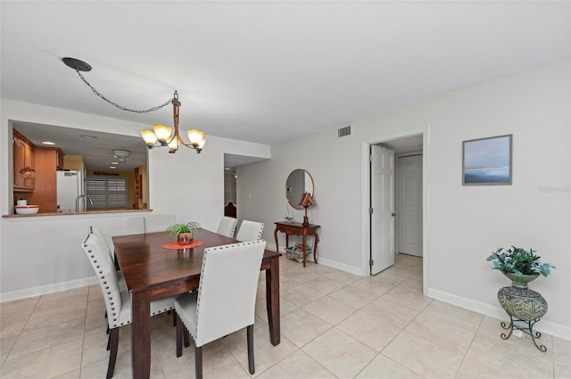 dining space featuring an inviting chandelier and light tile patterned flooring