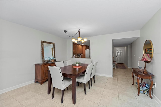 tiled dining area featuring a notable chandelier