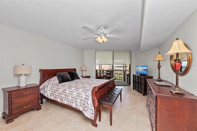 tiled bedroom with ceiling fan, access to exterior, and a wall of windows