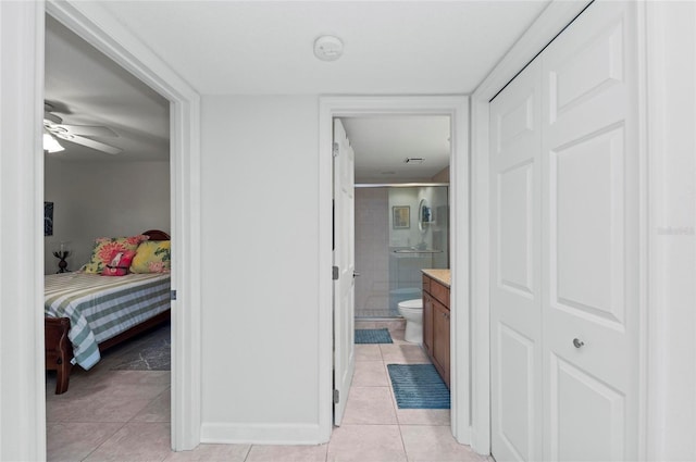 bathroom featuring vanity, walk in shower, ceiling fan, toilet, and tile patterned floors