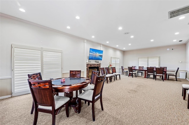 dining space with light colored carpet and ornamental molding