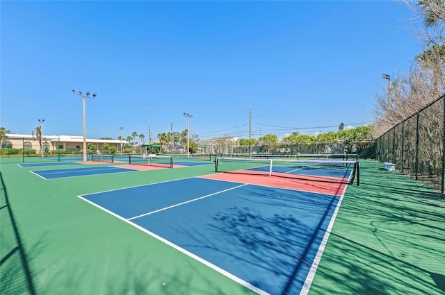 view of tennis court featuring basketball hoop