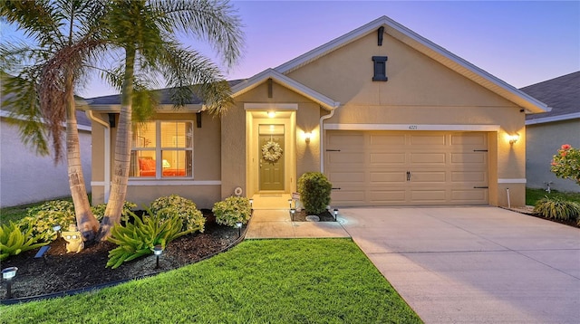 single story home with a garage, concrete driveway, and stucco siding