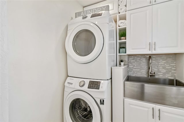 2375 Riverwood Pines Dr, Sarasota, FL 34231 - clothes washing area with cabinets, stacked washer and clothes dryer, and sink