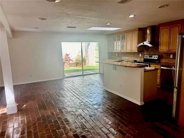 2375 Riverwood Pines Dr, Sarasota, FL 34231 - kitchen featuring sink, appliances with stainless steel finishes, a kitchen breakfast bar, tasteful backsplash, and wall chimney exhaust hood