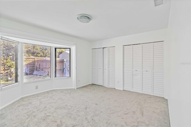 2375 Riverwood Pines Dr, Sarasota, FL 34231 - unfurnished bedroom with two closets and light colored carpet