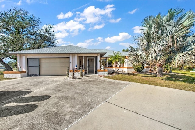 view of front of home featuring a garage and a front lawn