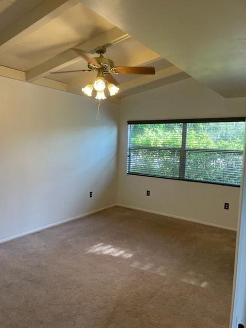 unfurnished room with vaulted ceiling, carpet floors, a wealth of natural light, and a ceiling fan