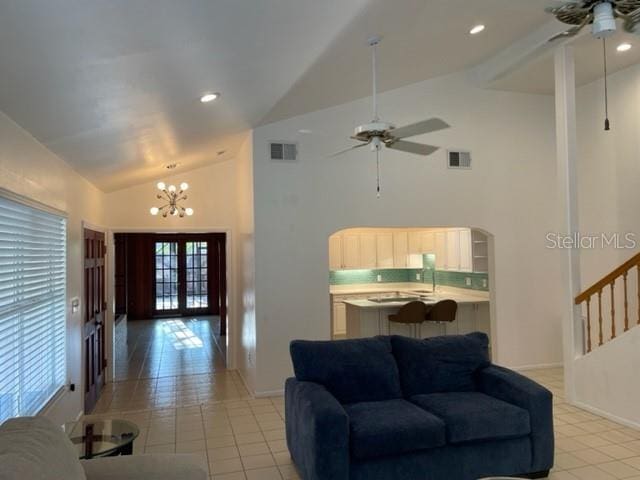 living area featuring visible vents, a ceiling fan, and french doors