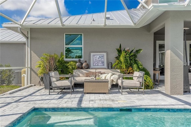 view of swimming pool featuring a patio, an outdoor hangout area, and glass enclosure