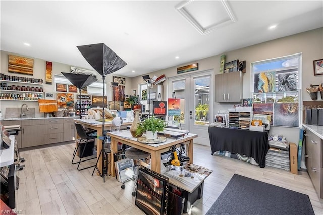 kitchen featuring gray cabinets, light hardwood / wood-style floors, and a healthy amount of sunlight