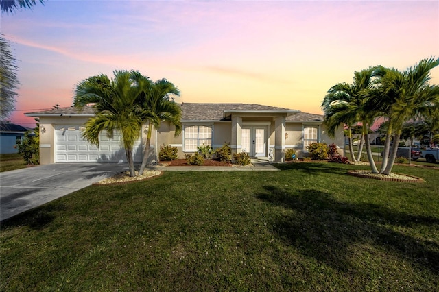 421 SW 19th St, Cape Coral, FL 33991 - view of front facade with a garage, a yard, and french doors