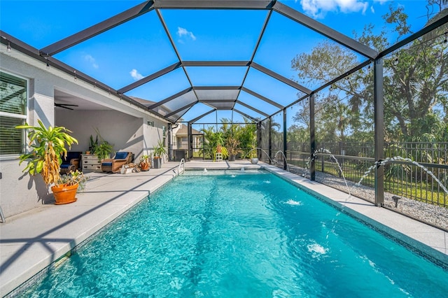 view of pool with a lanai, a patio, and pool water feature