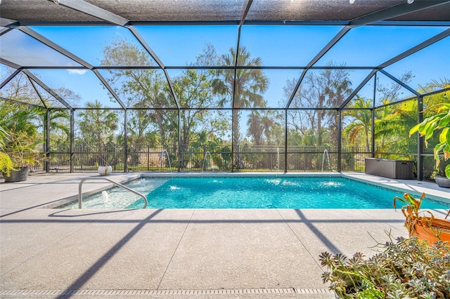 view of swimming pool with a patio and glass enclosure