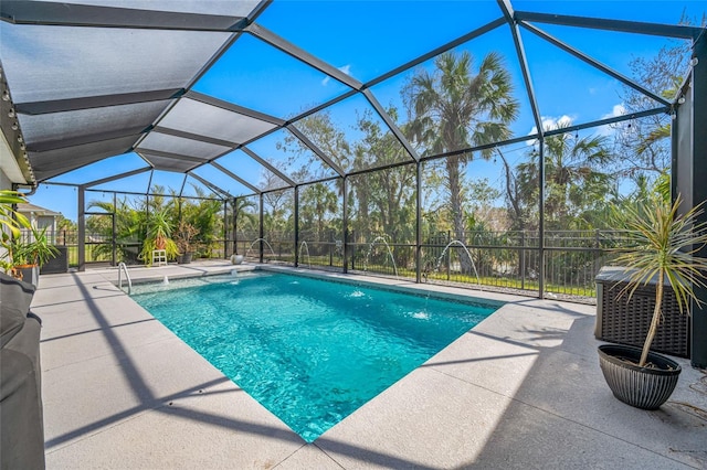 view of pool with a patio, a lanai, and pool water feature