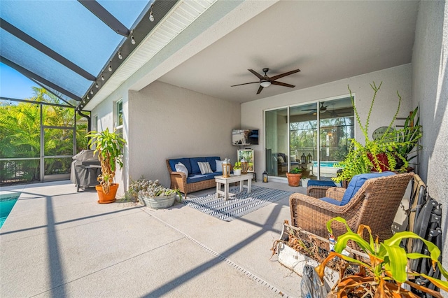 view of patio with an outdoor living space, grilling area, ceiling fan, and glass enclosure