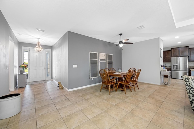 dining space featuring ceiling fan with notable chandelier and light tile patterned floors