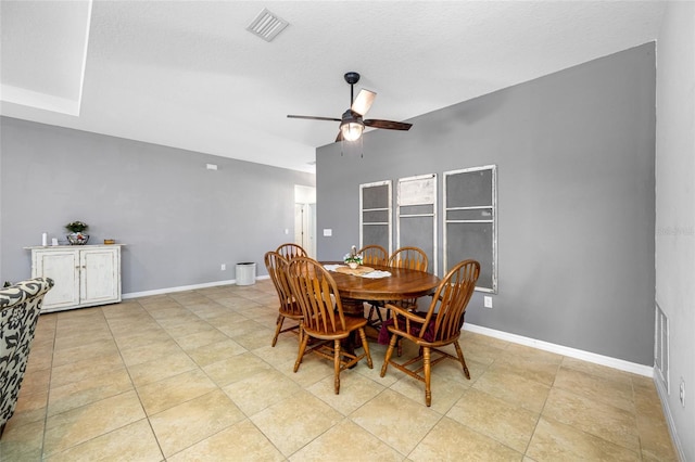 dining space with light tile patterned floors, a textured ceiling, and ceiling fan