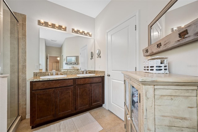 bathroom with vanity and a shower with door