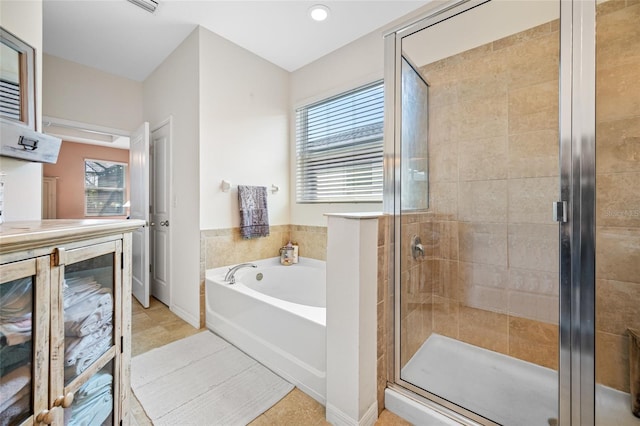 bathroom featuring independent shower and bath and tile patterned floors