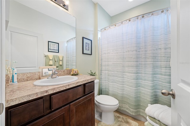 bathroom featuring vanity, a shower with shower curtain, and toilet