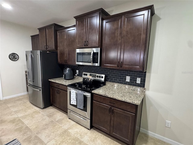 5821 Hevena Ct, Palmetto, FL 34221 - kitchen featuring appliances with stainless steel finishes, baseboards, tasteful backsplash, and dark brown cabinets