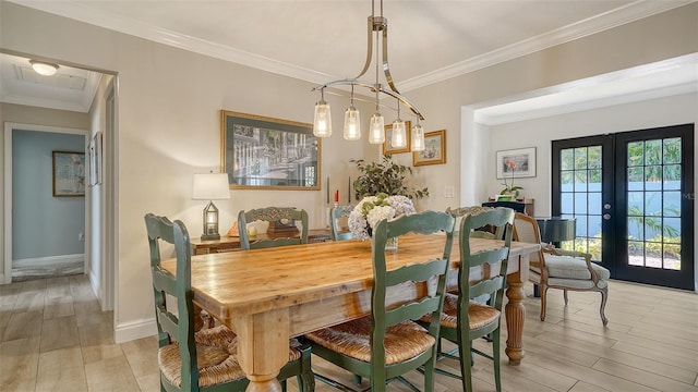 dining area with crown molding, light hardwood / wood-style floors, and french doors