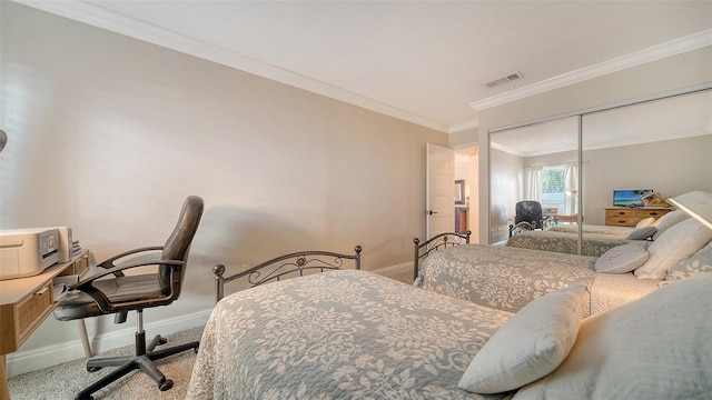 bedroom featuring crown molding, a closet, and carpet flooring