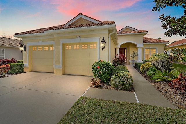 mediterranean / spanish house with a garage